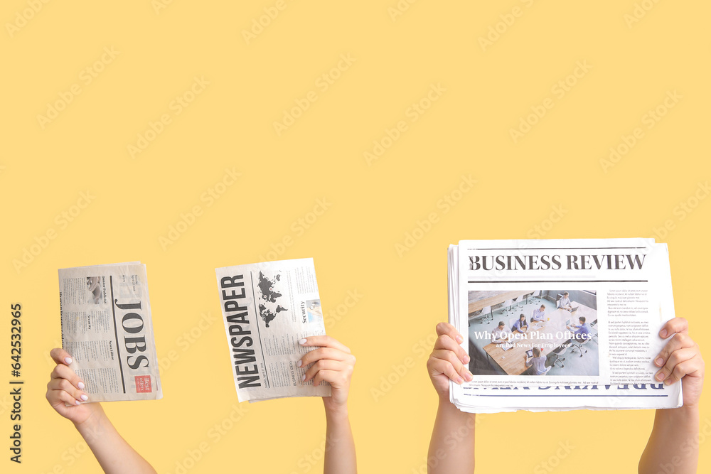 Female hands with different newspapers against color background