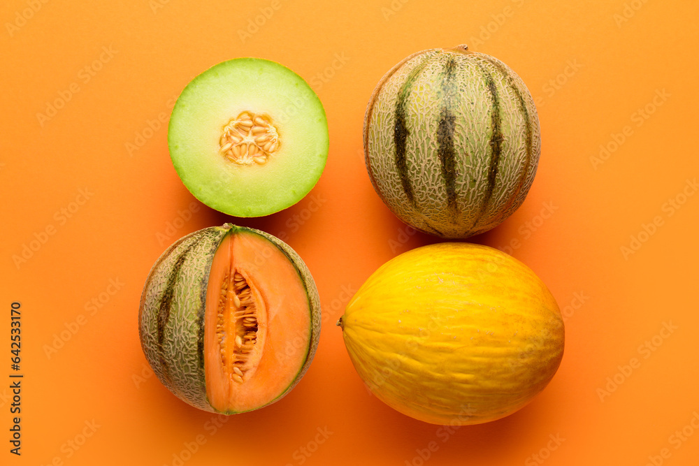 Tasty ripe melons on orange background