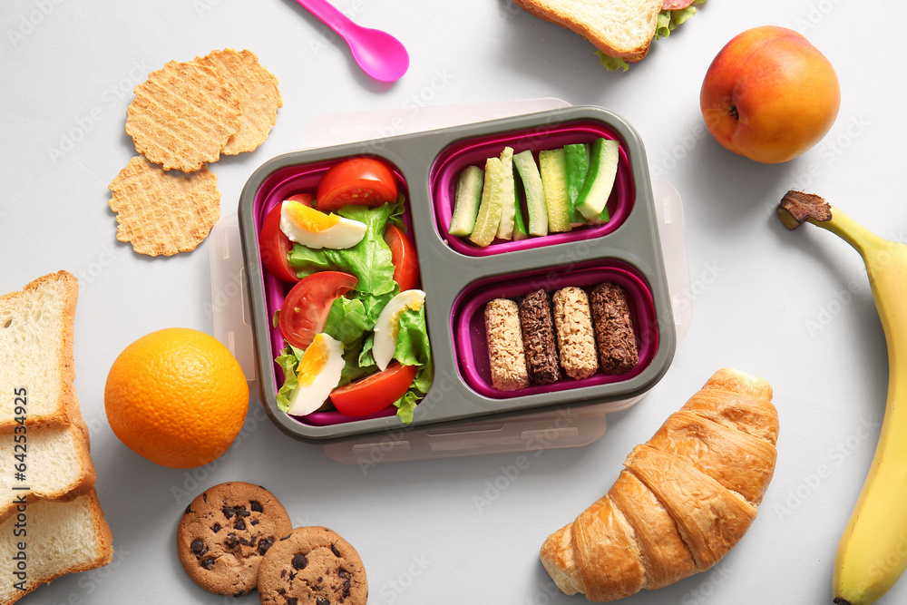 Lunchbox with different delicious food on white background