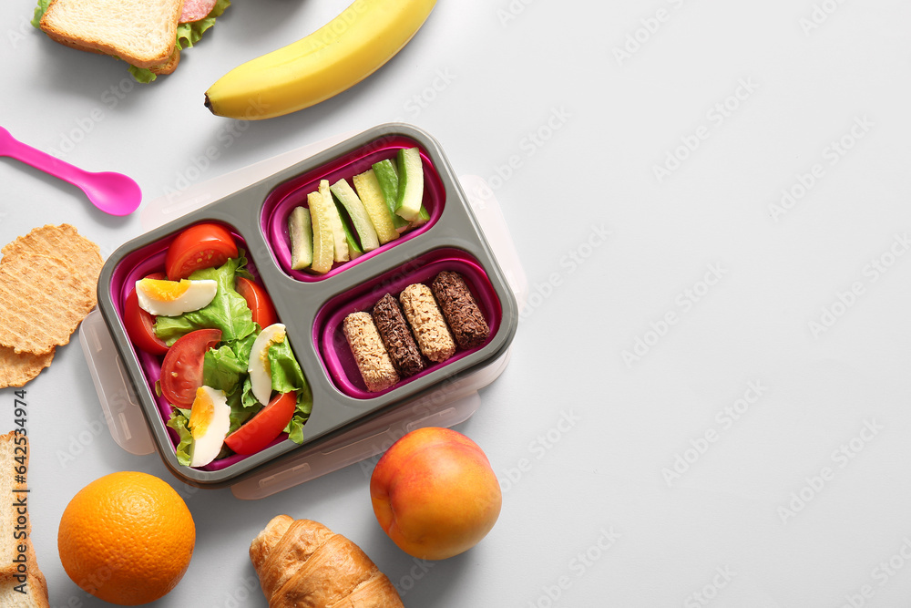 Lunchbox with different delicious food on white background