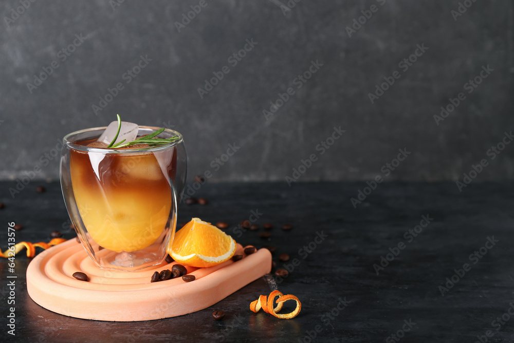 Glass of cold orange espresso on table