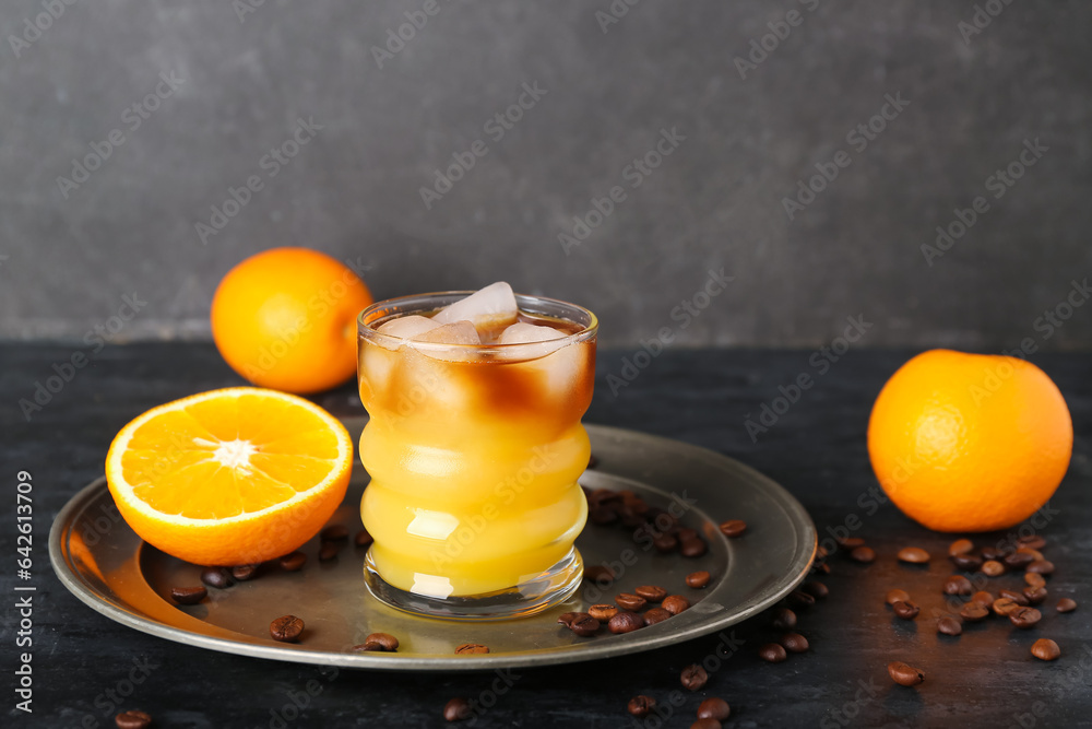 Glass of cold orange espresso on table