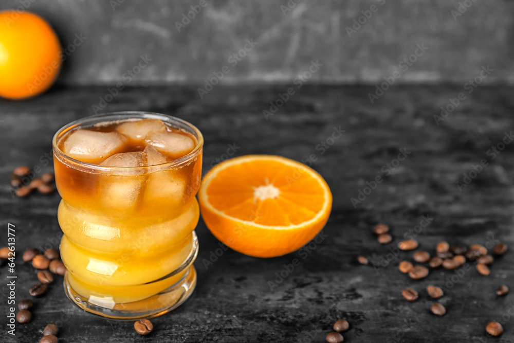 Glass of cold orange espresso on table