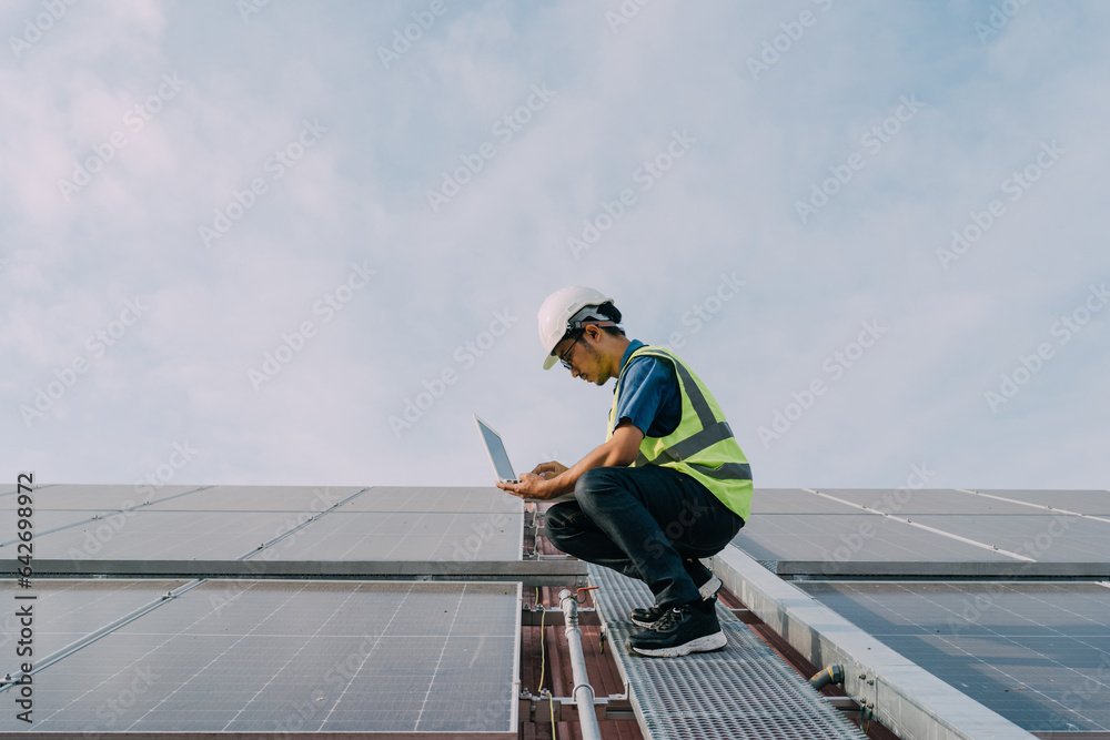 Engineers wearing a uniform walking on roof inspect and check solar cell panel, solar cell is smart 