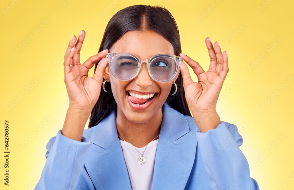 Funny, silly woman and sunglasses with tongue out, comedy and face in a studio. Yellow background, c