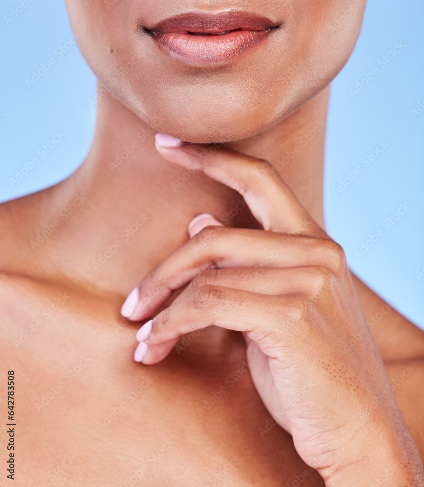 Hand, mouth and beauty with a woman closeup in studio on a blue background for natural skin wellness