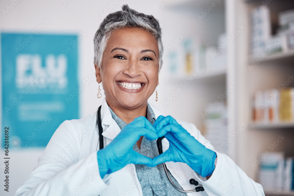 Senior, happy woman and portrait of doctor with heart sign for healthcare, service or love at hospit