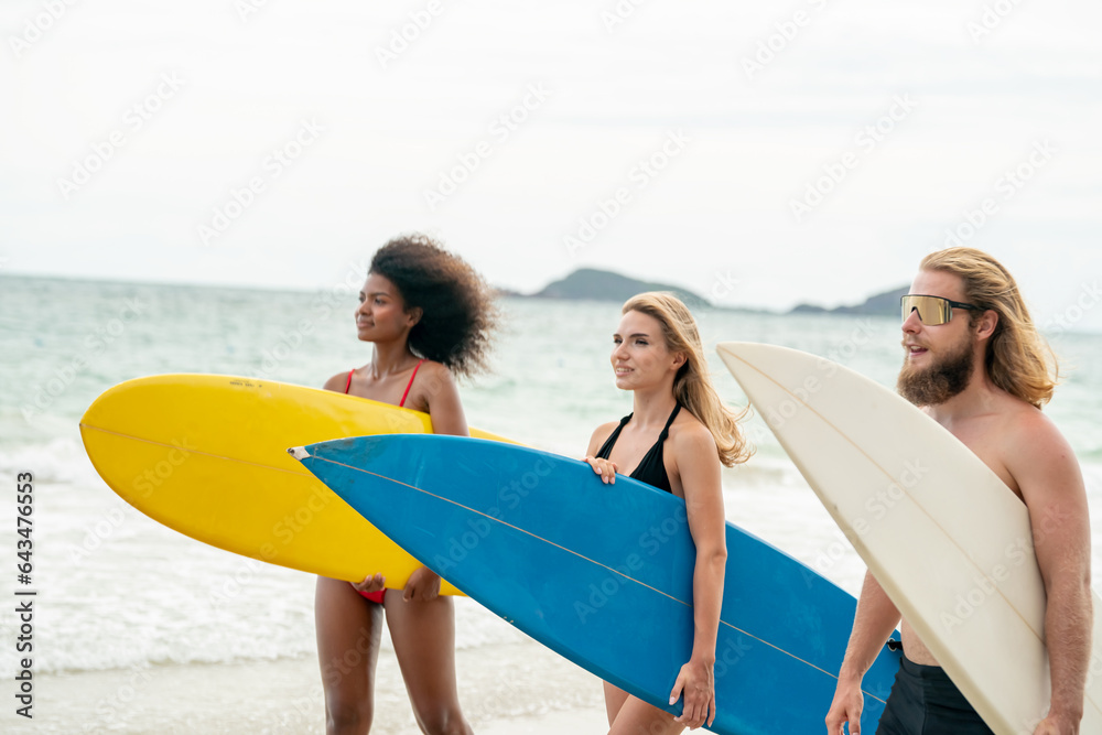 Happy friends with surfboards on the beach