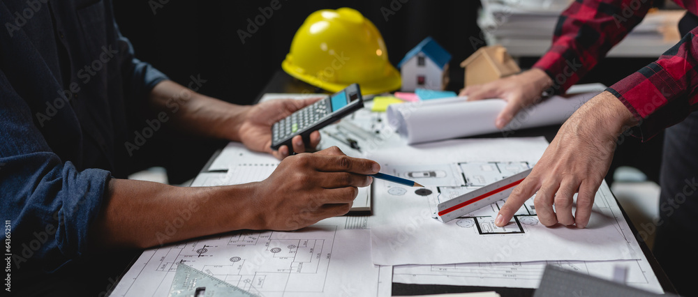 Team of engineers reviewing blueprints Sketch of a new construction project with engineering tools a