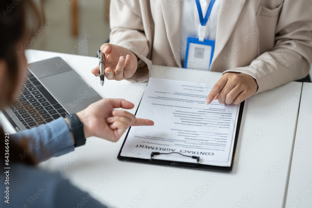 Businesswoman, office worker working using laptop and mobile phone in real estate accounting analysi