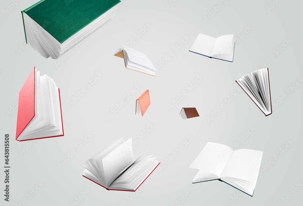 Many flying books on light background