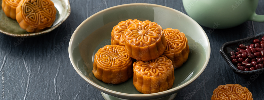 Delicious Cantonese moon cake for Mid-Autumn Festival food mooncake on blue table background.