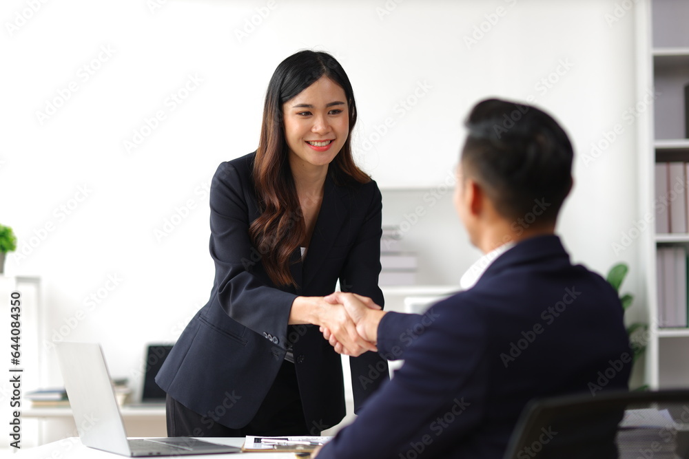 Business partners and colleagues shaking hands at work cooperation. Job applicant shaking hands with