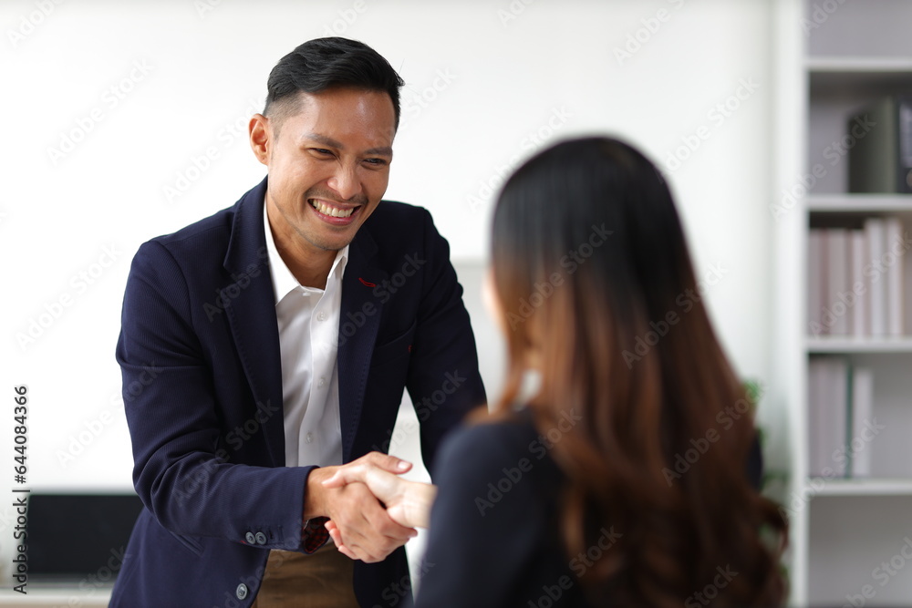 Business partners and colleagues shaking hands at work cooperation. Job applicant shaking hands with