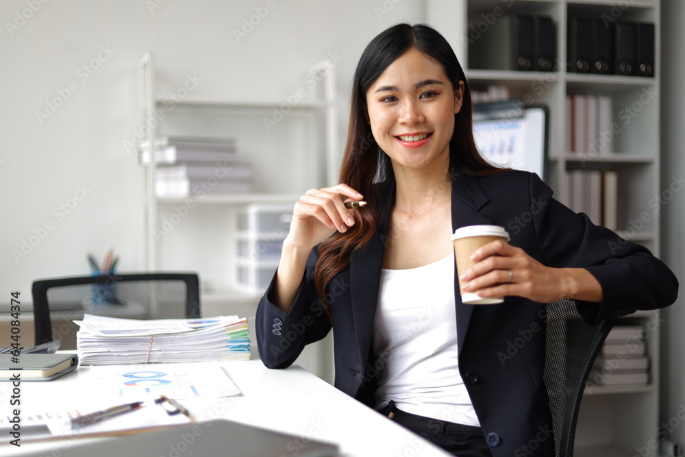 Portrait of a charming Asian businesswoman working in the office.