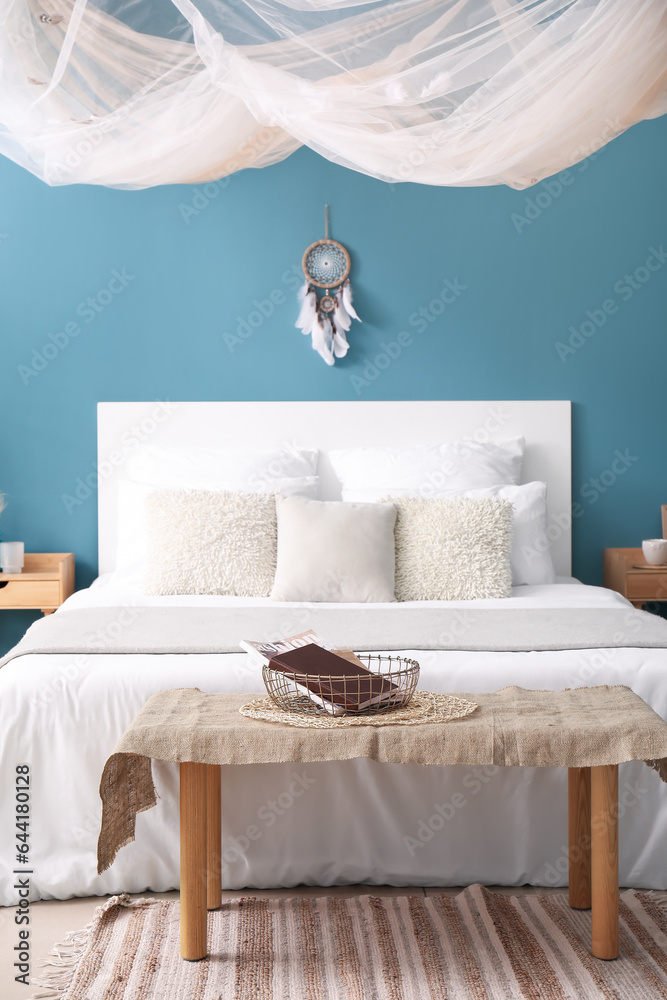 Interior of bedroom with dream catcher and bed