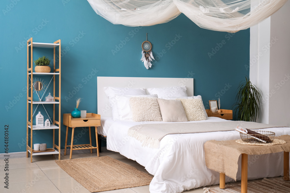 Interior of bedroom with dream catcher and bed