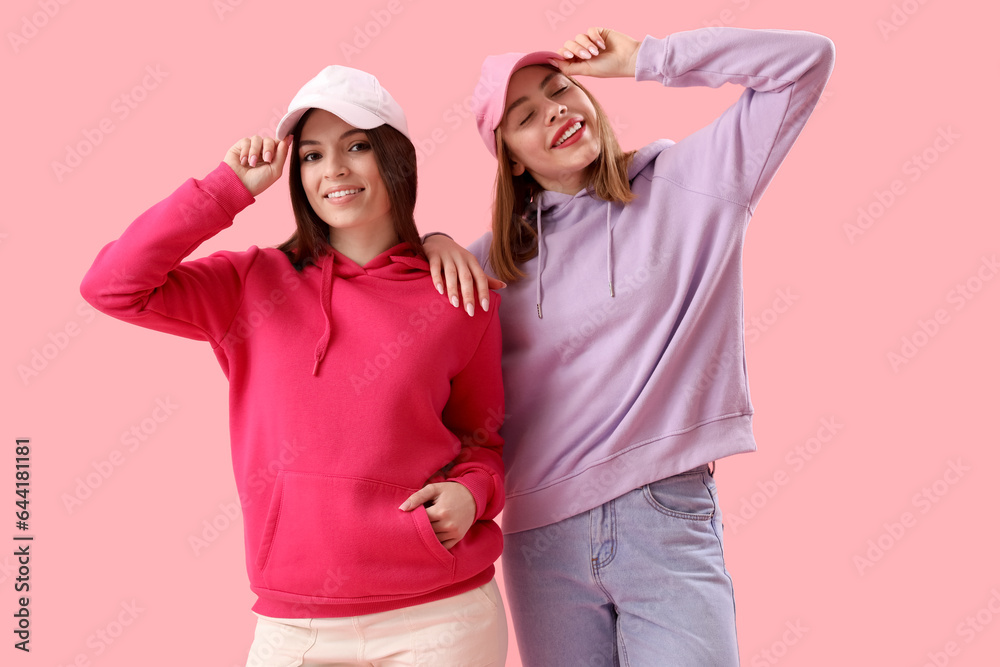 Female friends on pink background