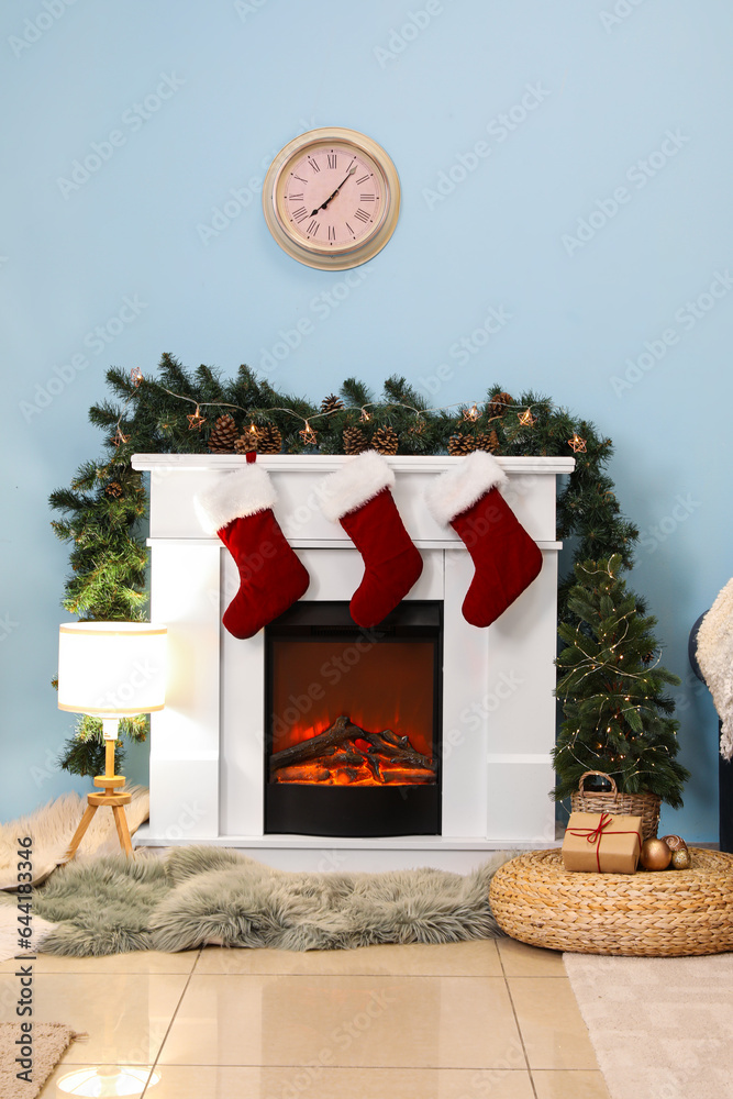 Fireplace with Christmas socks and decorations in living room