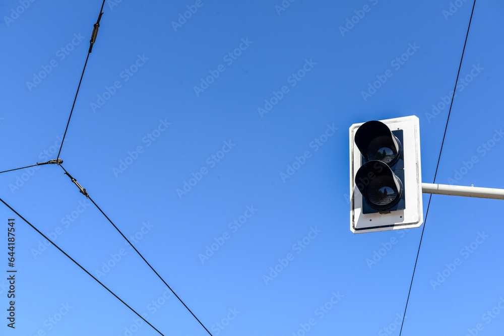 View of traffic lights against blue sky, closeup