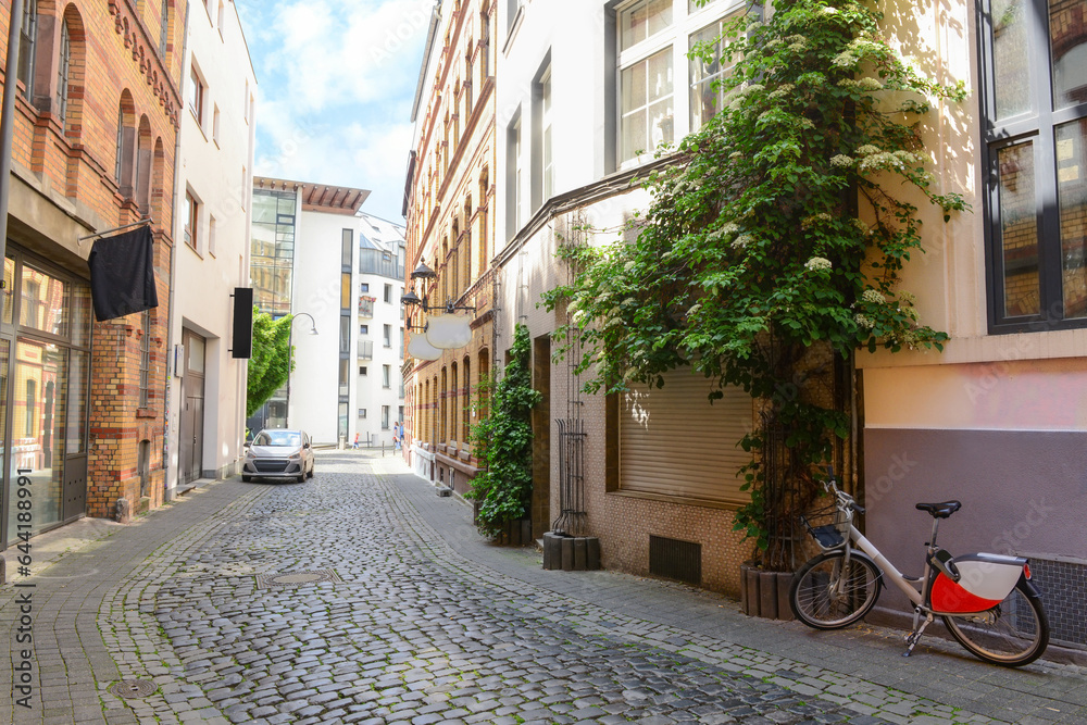 View of old houses with paving stones on city street