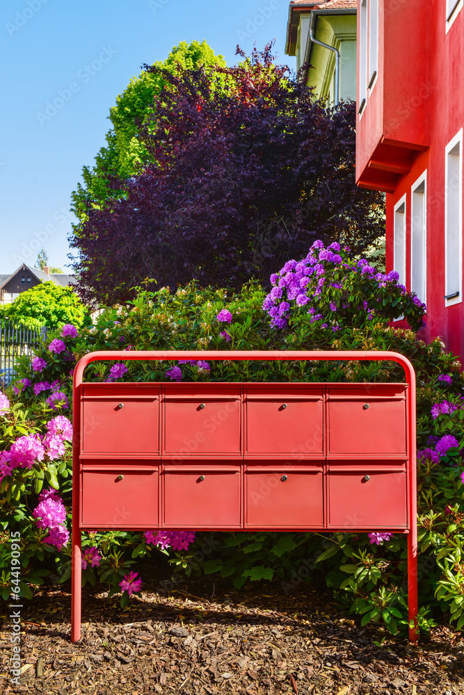 View of red mailboxes and flowers on street