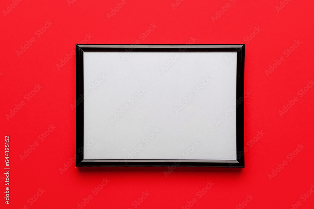 Blank picture frame on red background