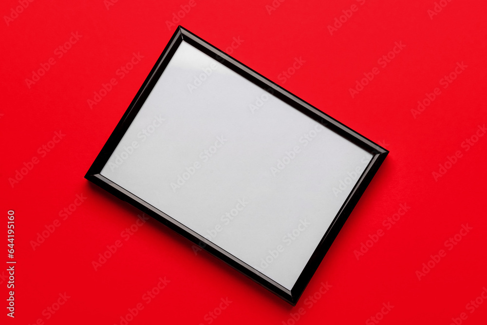 Blank picture frame on red background