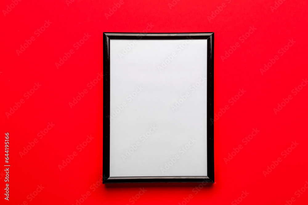 Blank picture frame on red background