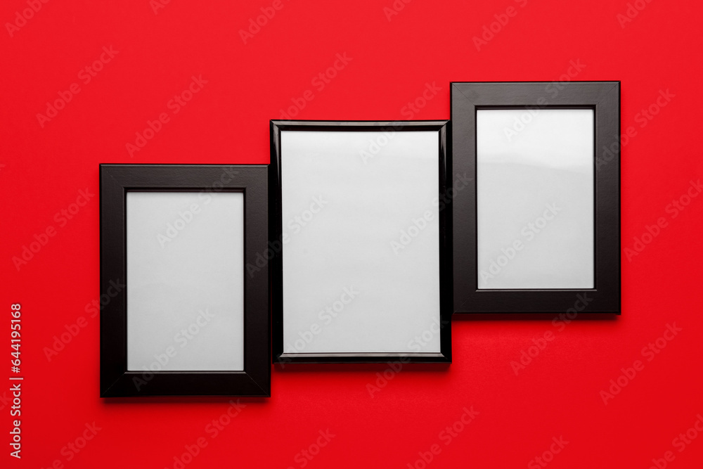 Blank picture frames on red background