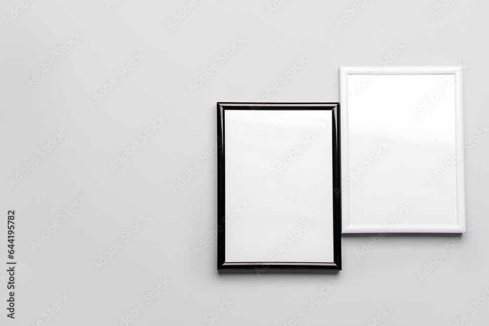 Blank picture frames on light background