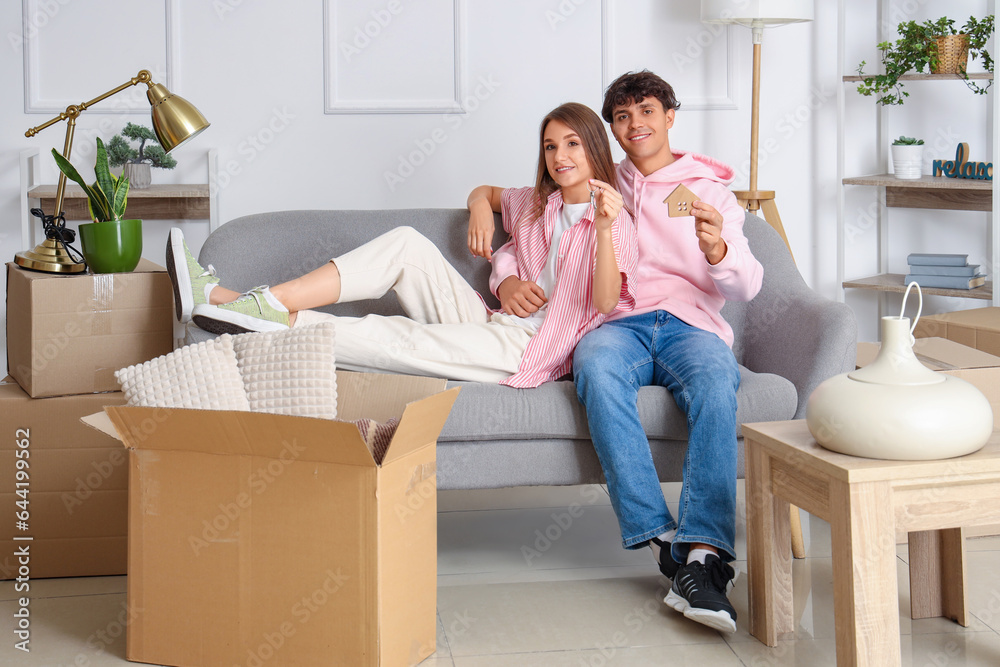 Young couple with keys in their new flat