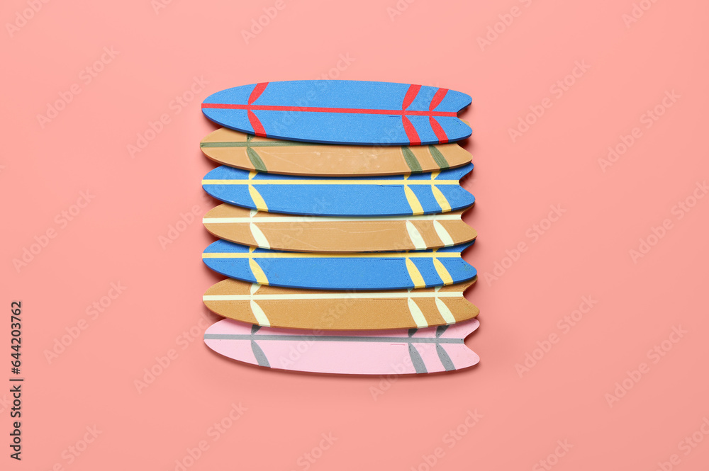 Different mini surfboards on pink background