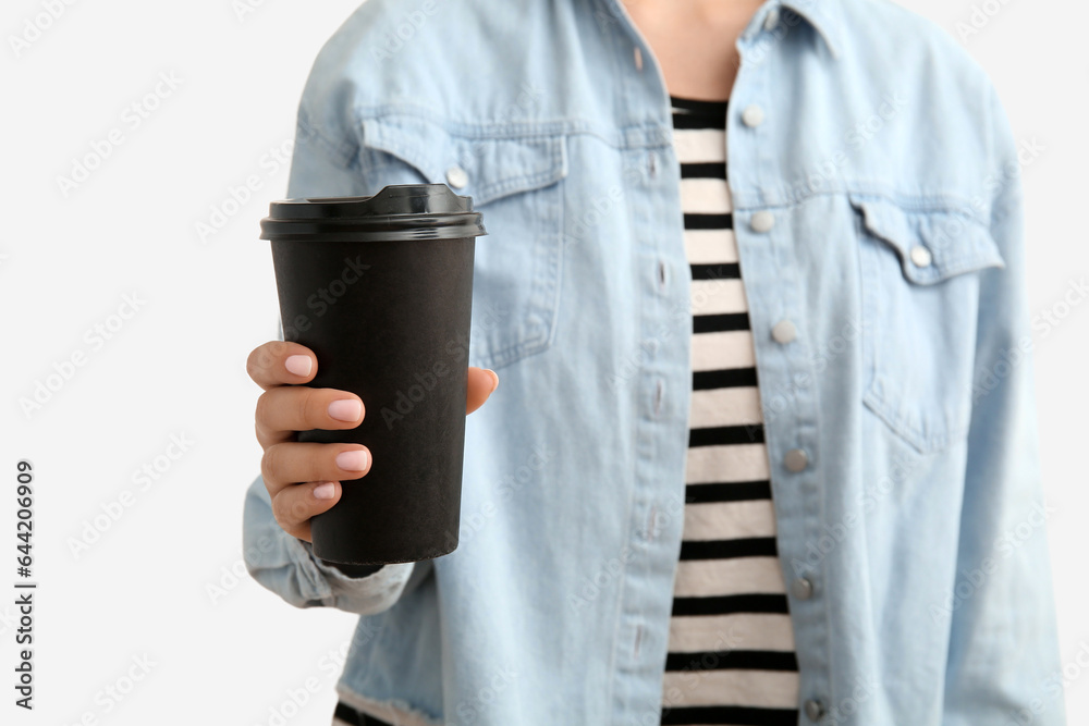 Woman with takeaway cup of hot coffee on white background