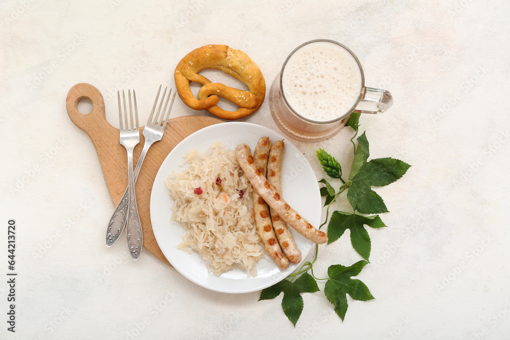 Plate with tasty Bavarian sausages, sauerkraut, pretzel and mug of beer on beige background. Oktober