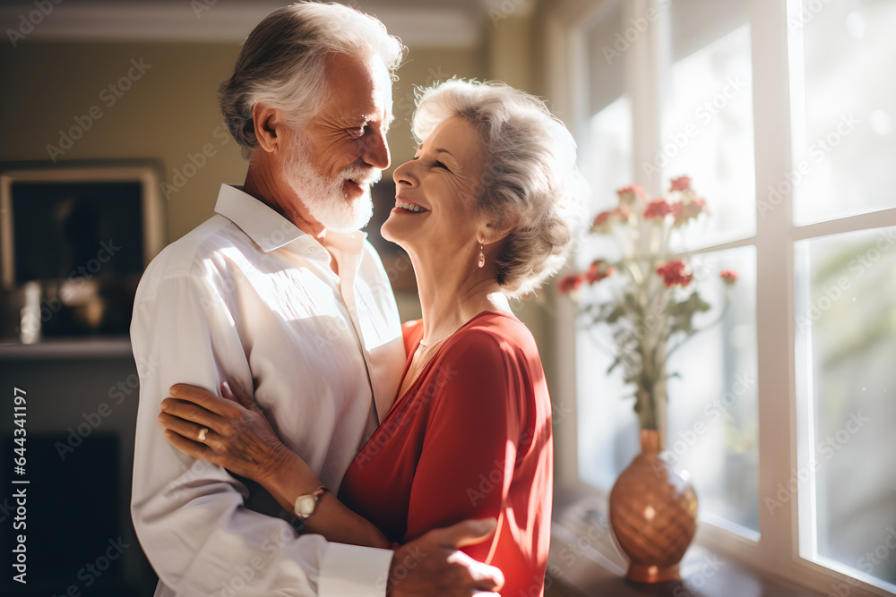 Happy cheerful senior couple dancing together at home, romantic old mature man and woman having fun 