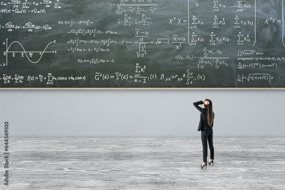 Thoughtful young european businesswoman standing in modern classroom interior with formulas on chalk