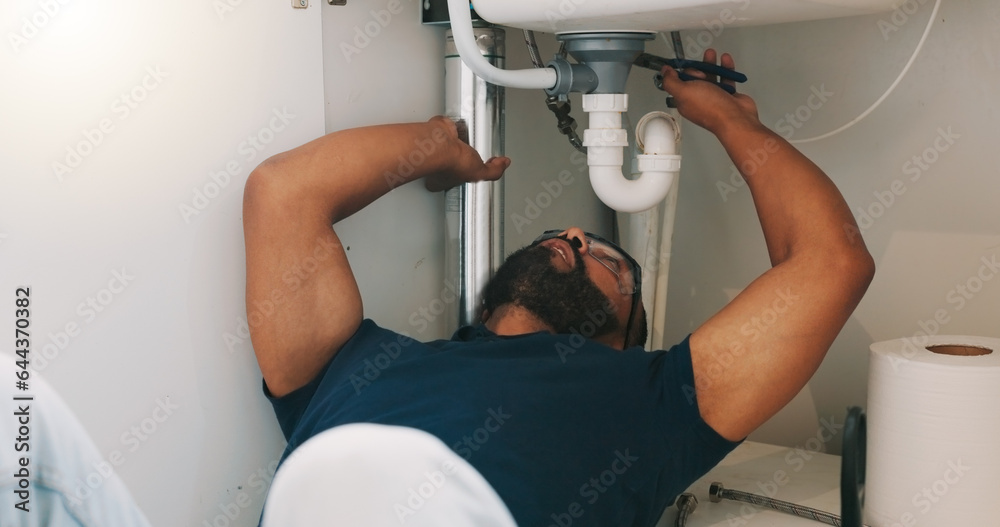 Plumber black man, kitchen and sink maintenance with tools, focus and pipe repair for drainage in ho