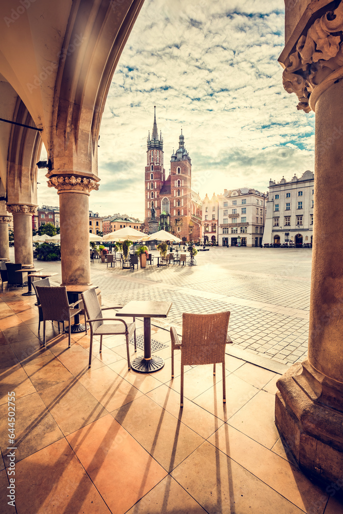 Restaurant table and chairs on old town in Cracow, Poland. View from Cloth hall at sunrise