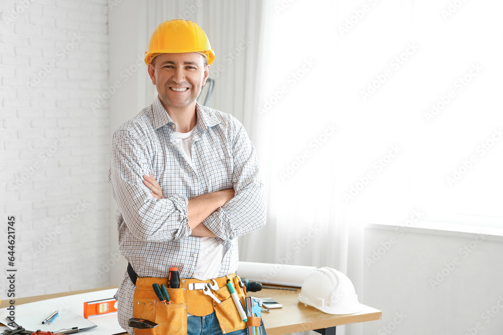 Mature builder working in room