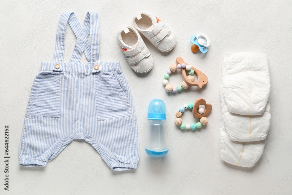 Composition with baby accessories and clothes on light background