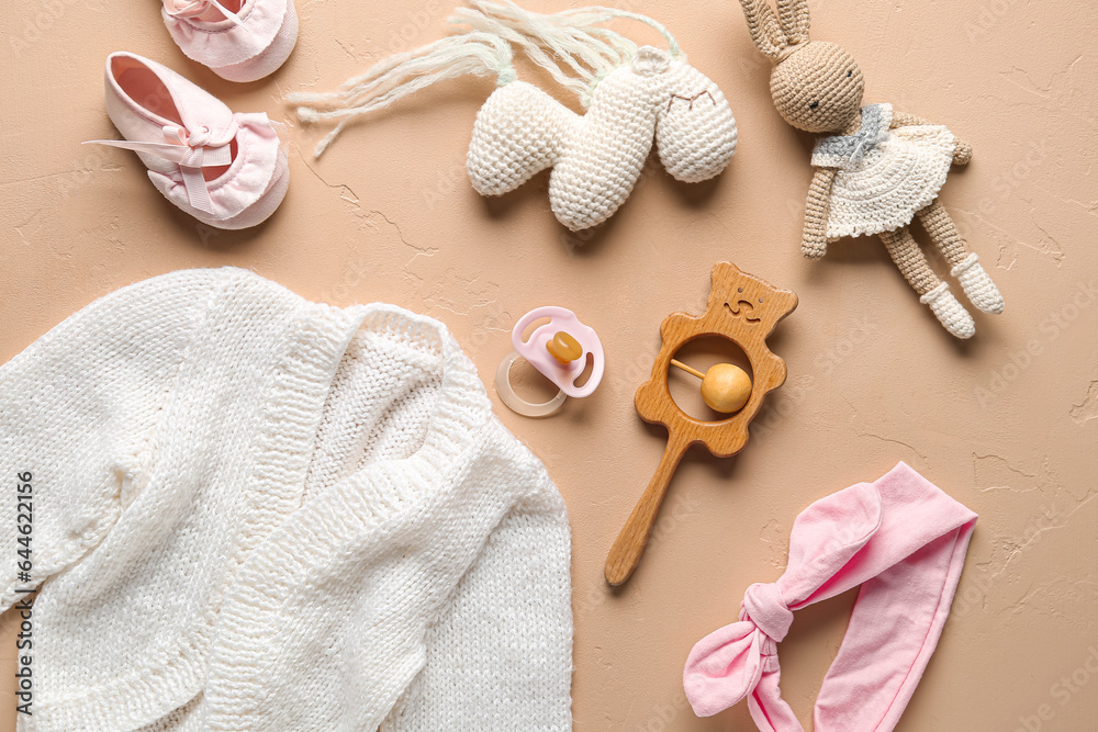 Set of baby toys and accessories on color background