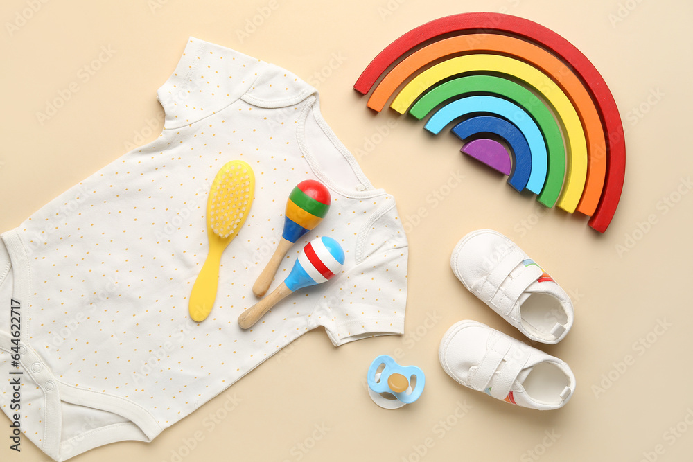 Composition with baby toys, clothes and accessories on color background