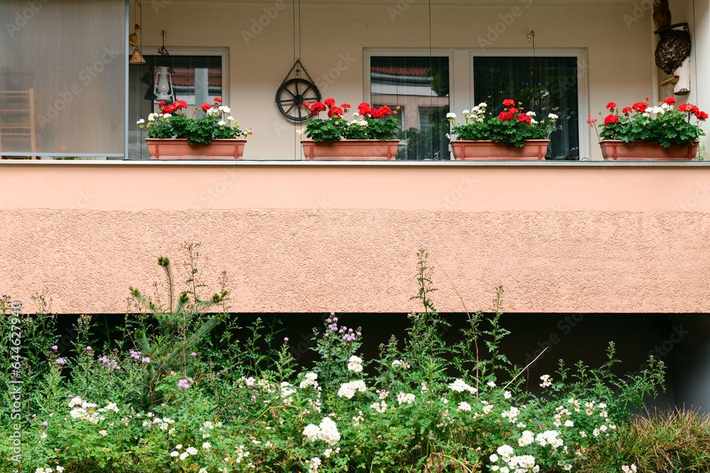 View of house with beautiful flowers on balcony