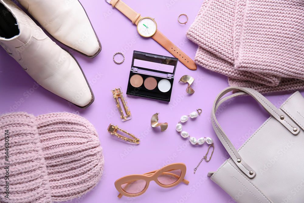 Composition with stylish female accessories, clothes and eyeshadows on lilac background