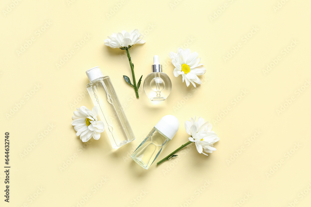 Composition with cosmetic products and chamomile flowers on color background