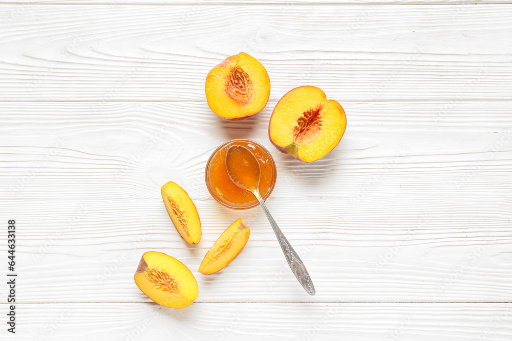 Bowl with delicious peach jam and fresh fruits on wooden background