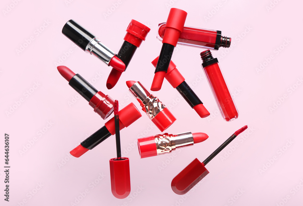 Red lipsticks flying on pink background