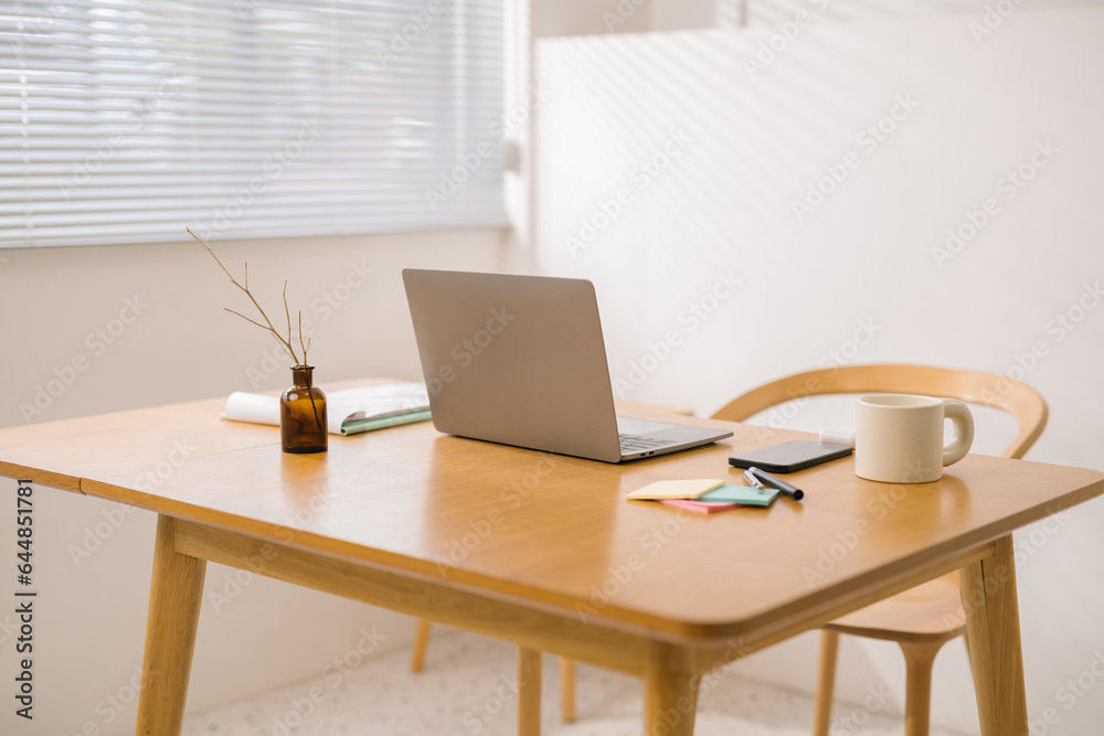 Laptop and documents on wooden work desk at home, comfortable workspace, workplace with computer in 