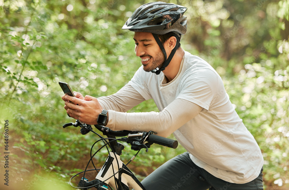 Man, forest and phone on bike, texting and smile for web chat notification on adventure in nature. G